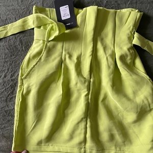 Tag in neon green skirt